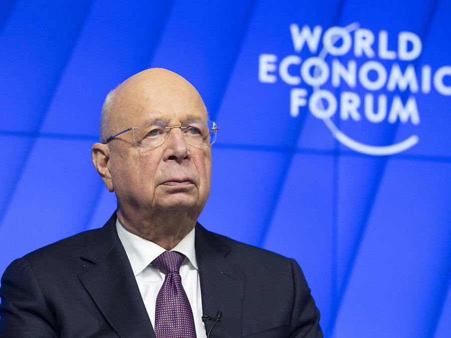 Klaus Schwab speaking at the World Economic Forum, WEF logo in the background.