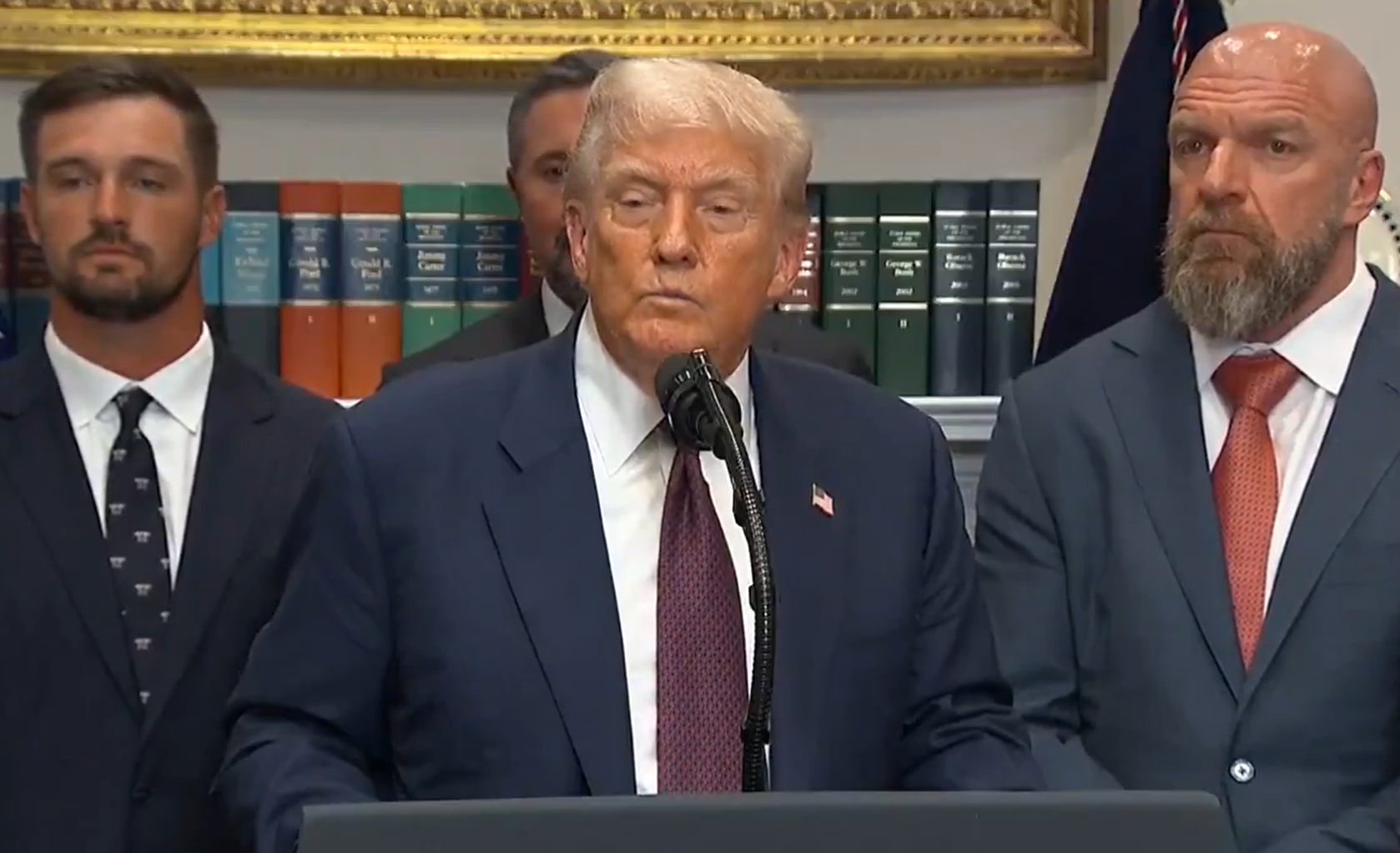 Donald Trump announces tariffs 2025 during America First press briefing at White House, flanked by advisors and officials