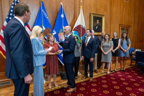 U.S. Attorney General Pam Bondi leads an official oath-taking ceremony at the Department of Justice, with guests and department officials in attendance.