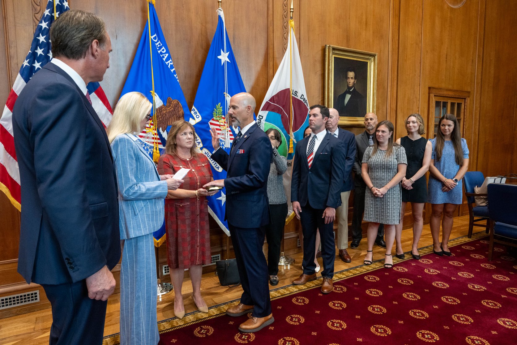 U.S. Attorney General Pam Bondi leads an official oath-taking ceremony at the Department of Justice, with guests and department officials in attendance.